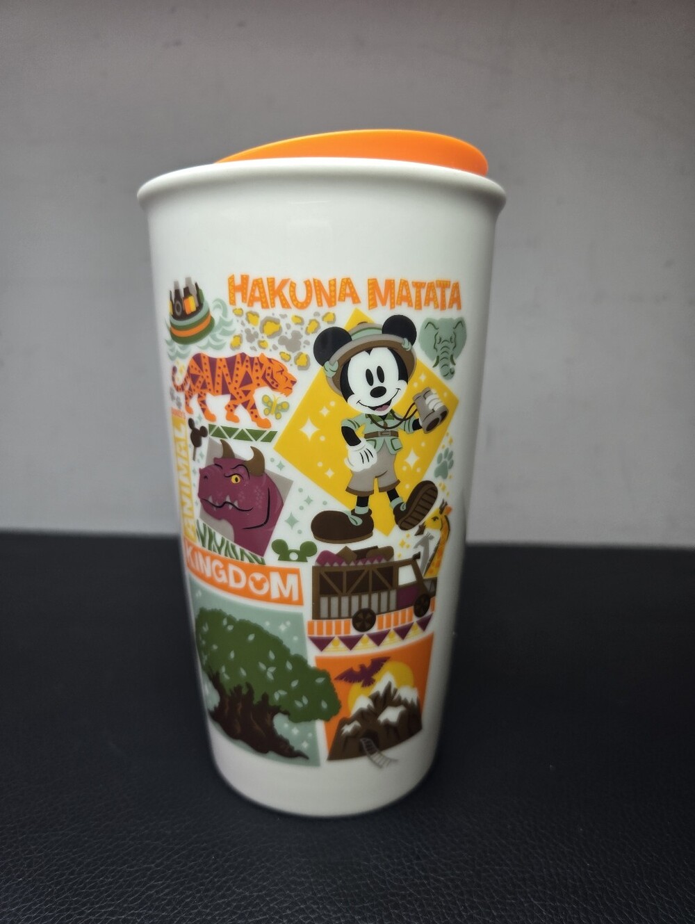 Safari Mickey Mouse alongside iconic park attractions, including the Tree of Lif